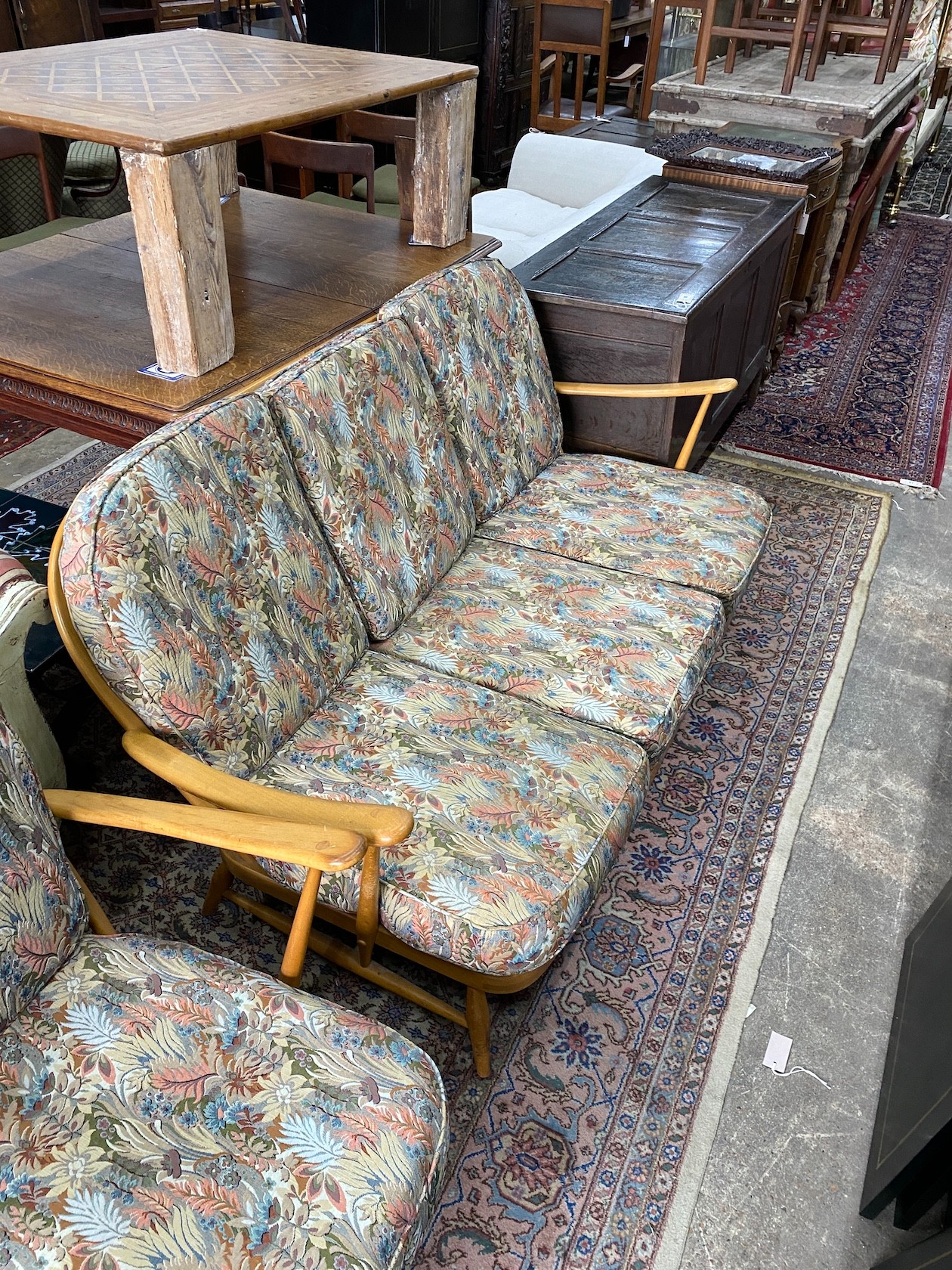 An Ercol beech three piece lounge suite and footstool, settee length 174cm, width 80cm, height 82cm